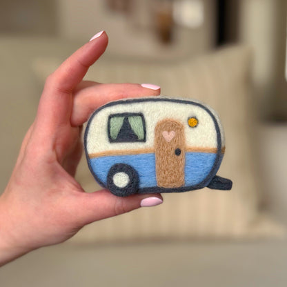 Hand holding the front of the finished Happy Camper Feltie, a beginner-friendly needle-felting project from Feltie Kits