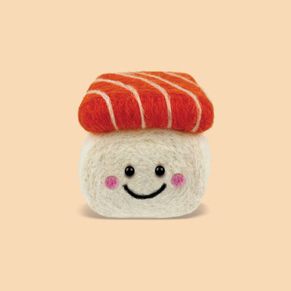 Finished Salmon Sushi Feltie made from the Feltie Kits needle felting kit, showing the smiling rice base and orange wool salmon topper.