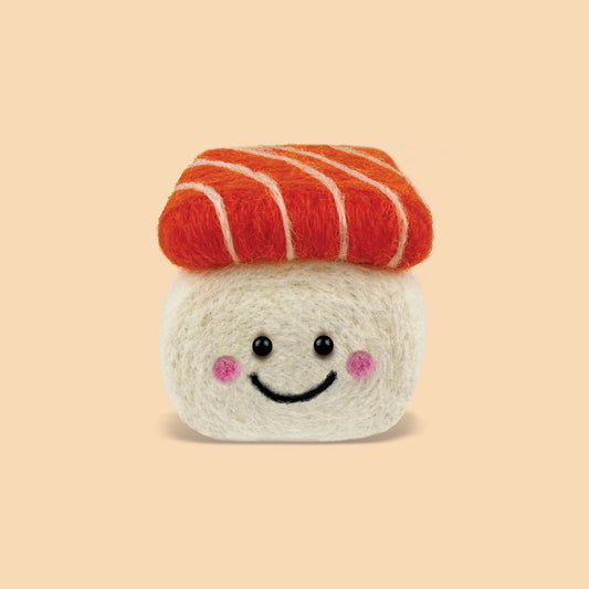 Finished Salmon Sushi Feltie made from the Feltie Kits needle felting kit, showing the smiling rice base and orange wool salmon topper.