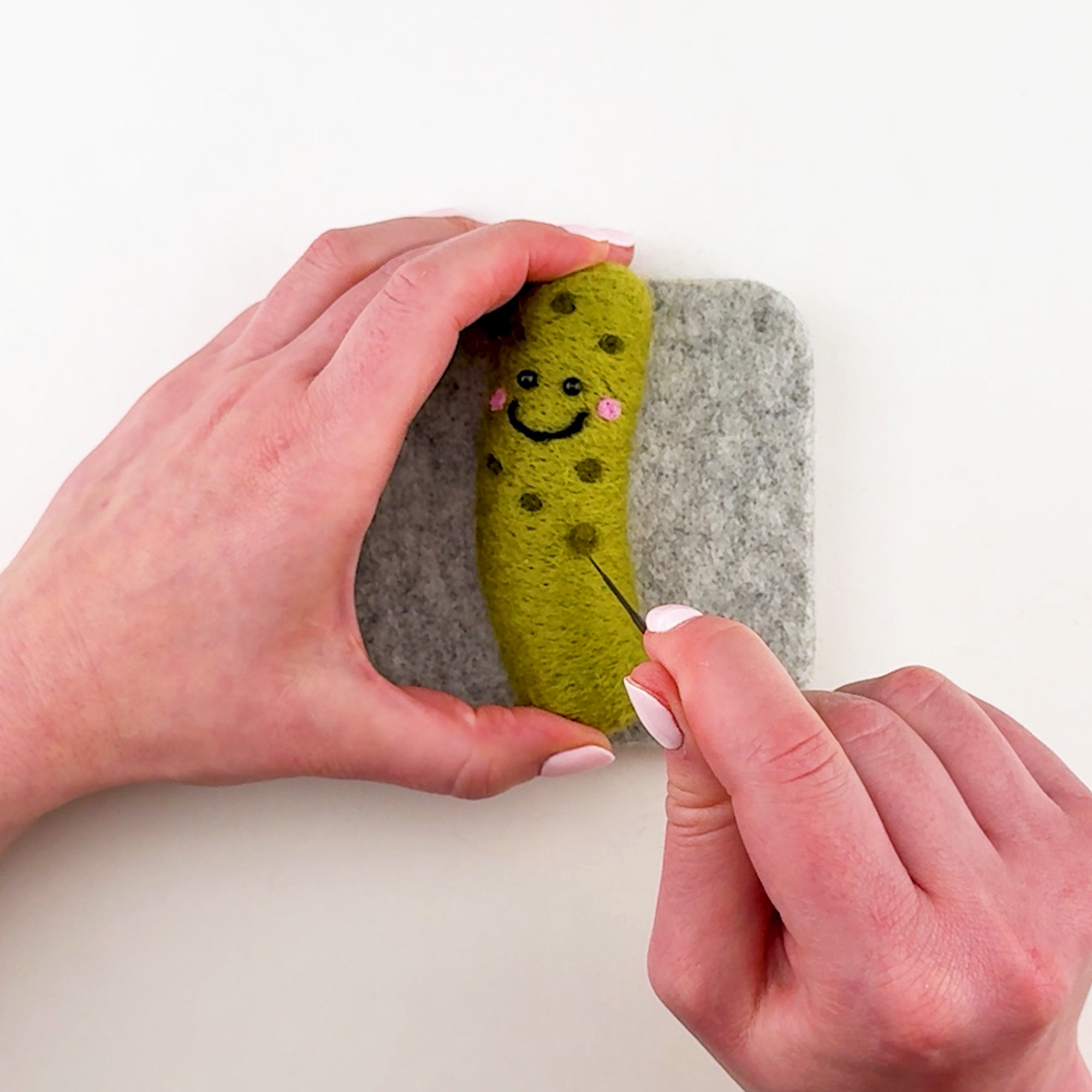 Step-by-step needle felting tutorial for The Big Dill Pickle from Feltie Kits, showing how to add the dimples.
