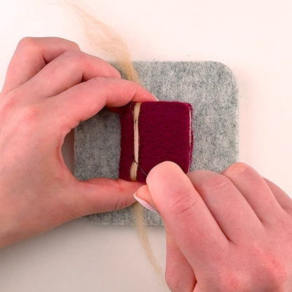 Step-by-step needle felting tutorial for The Storybook Stack from Feltie Kits, showing how to add the book spine accent.